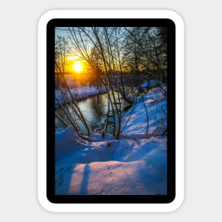 Snow falling on a river with snowy banks Sticker